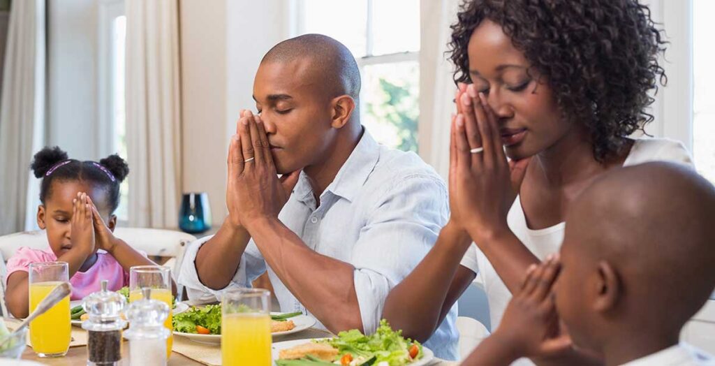 Family prays at meal