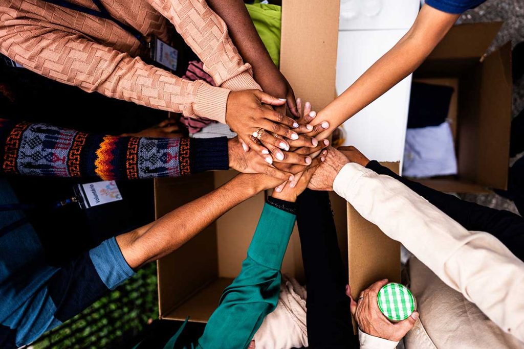 holding hands in solidarity - iStockphoto by FG Trade